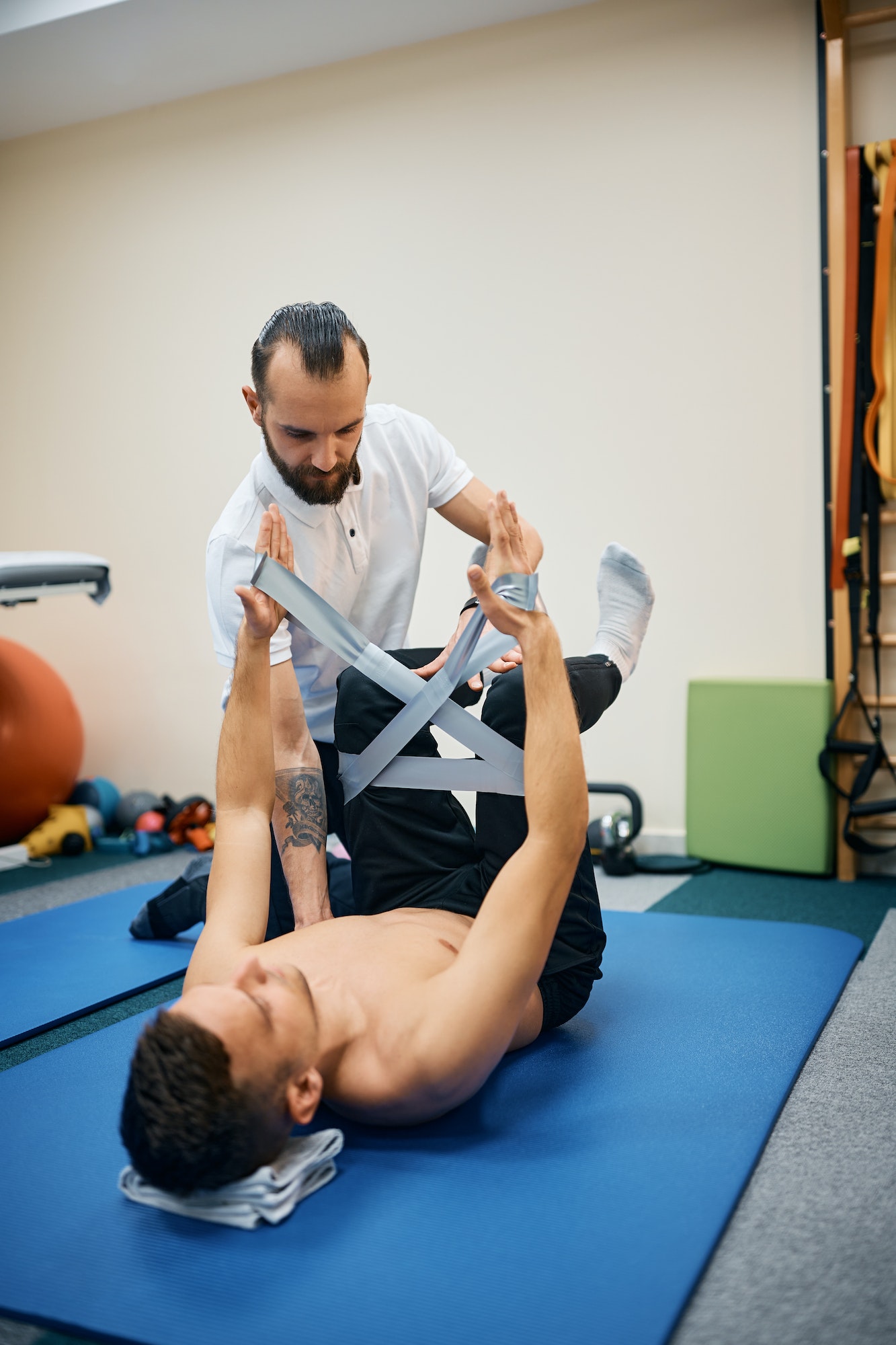Physical therapist working with male patient at rehabilitation center.